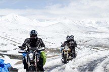 Group of bikers crossing Khardung La - one of the highest motorable roads in the world Group of bikers crossing Khardung La - one of the highest motorable roads in the world